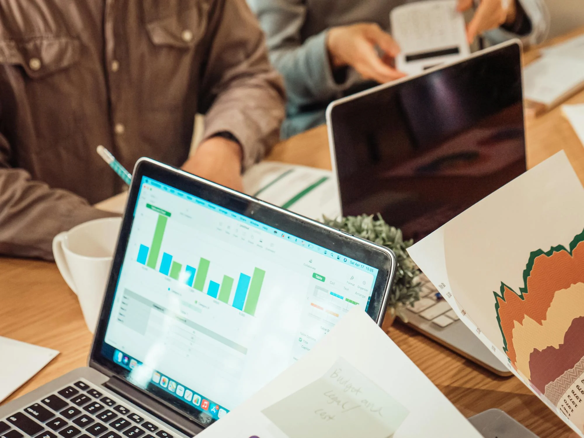 a laptop screen showing charts during group meeting