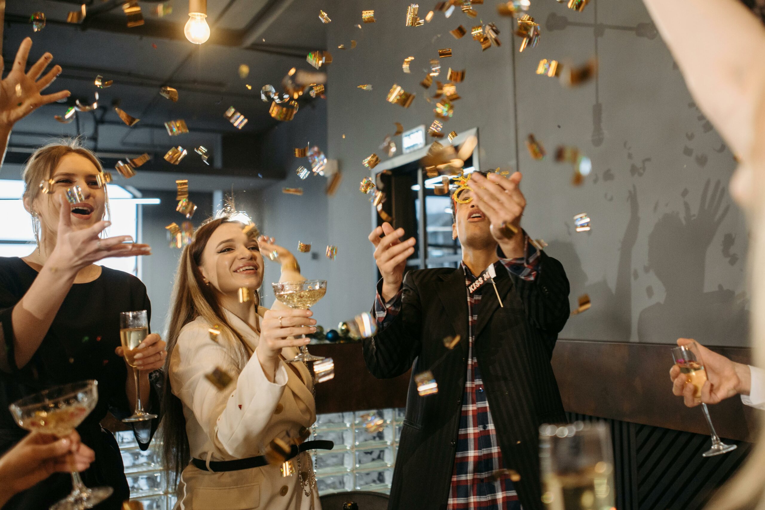A team celebrating achievement with gold confetti and champagne cheers